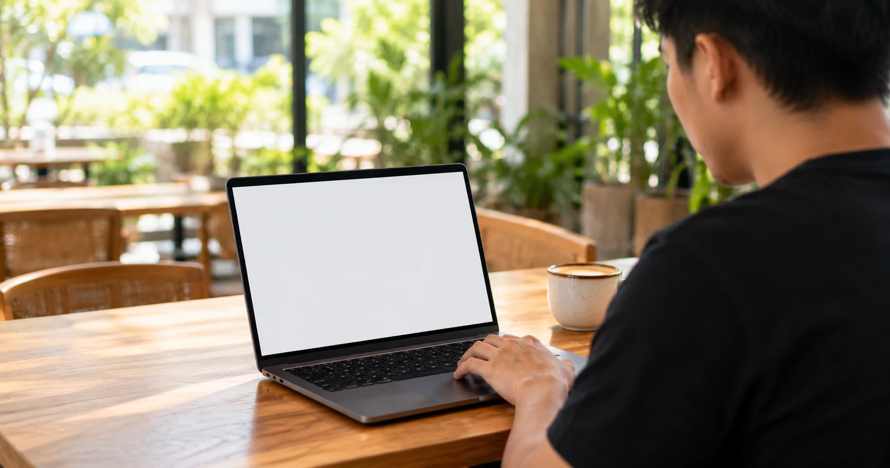 Illustrative café workspace with the CollectLah dashboard demo on a laptop, with an upward-trending example graph and monetary amounts hidden
